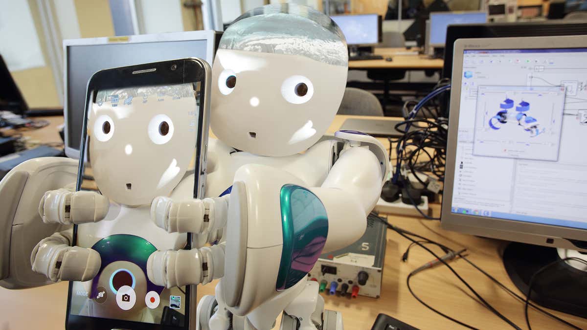 A robot holding a tablet