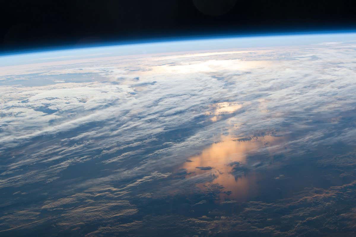 G5YCKR International Space Station Earth observation image captured by Expedition 48 crew members showing the sun reflecting off the ocean and the thin layer of atmosphere protecting the Earth from space.